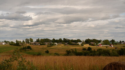 Wall Mural - Beautiful rustic summer landscape. Old wooden log houses. Vologda region