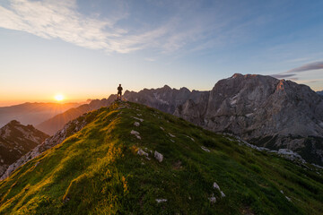 hiking at the top of the mountain at sunset