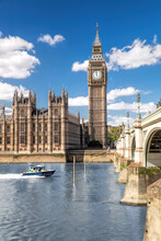 Famous Big Ben With Bridge Over Thames And Tour Boat On The River In London, England, UK