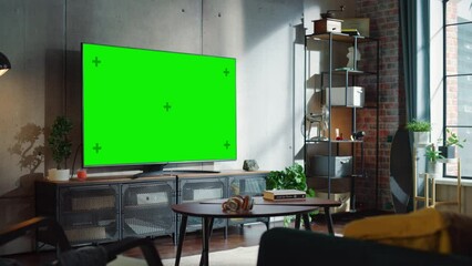 Poster - Modern Living Room Interior With Television Set with Green Screen Display, Sofa And Urban City View From The Window. Empty Apartments with Chroma Key Placeholder on Monitor