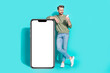 canvas print picture Photo of influencer blogger man hold telephone read message empty space wear pullover jeans isolated blue color background