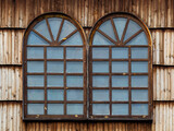 Fototapeta  - A wooden window in the church, an antique window, an old window frame and old panes. A beautiful, intimate facility, all built of wood. It was established many years ago.