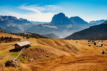 Seceda. Majestic Landscape Of Alpine Red Autumn Nature Seceda. Wonderful Hiking Nature Scenery In Dolomites. Wooden Chalets In Dolomites, Odle Mountain Range, Val Gardena. Majestic Furchetta Peak