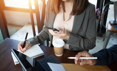 businesswoman hand working with laptop computer, tablet and smart phone in modern office with virtual icon diagram at modernoffice in morning light