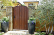 © Heidi Patricola - villa themed wood gate with stone pillars