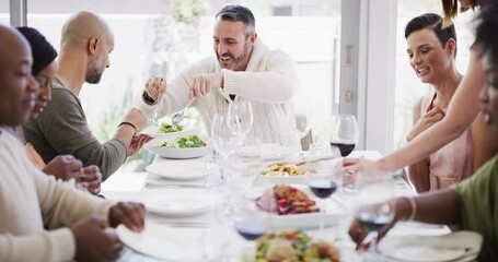 Poster - Diverse and mature group of friends eating, drinking and having lunch around a dining room table at home. Happy people smiling and laughing while enjoying food and wine during a day time get together