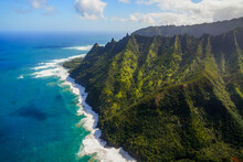 Aerial View Of The Dramatic Ridges Of The Na Pali Coast, Looming Over The Pacific Ocean On The Northwestern Side Of Kauai Island In Hawaii