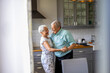 © pikselstock - Senior Couple Dancing in their Kitchen