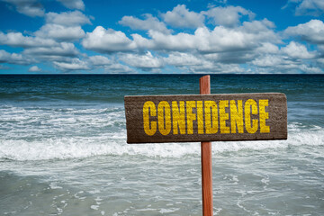 Confidence text written on a sign at the beach.