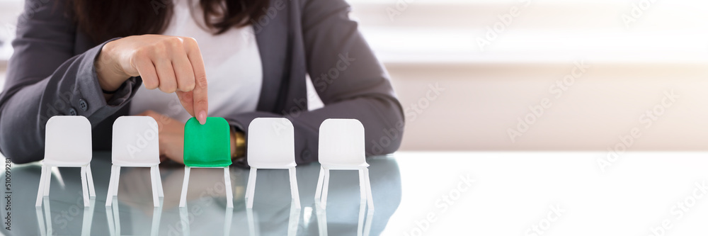 Businesswoman Choosing Green Chair Among White Chairs In A Row