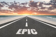 © Jay Koppelman - The word Epic on a highway leading into the sunset at the beach.