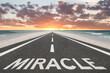 © Jay Koppelman - The word Miracle on a beacutiful road at the beach leading to the sunset.