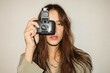 © Karyna Bartashevich/Stocksy - beautiful dark-haired girl makes a party photo on an old camera