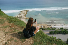 Girl Sitting On A Mountainside Near The Sea