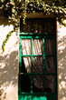 © Simone Anne/Stocksy - Green window frame with plants framing