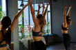 © Tatiana Timofeeva/Stocksy - women friends traning yoga class
