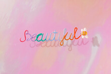 In The Center Of Colorful Background With The Words Beautiful