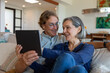 © McKinsey Jordan/Stocksy - Wife Shows Her Husband Something On Their Tablet