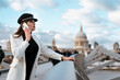 © Mauro Grigollo/Stocksy - Woman using her smartphone to call during a tour in London