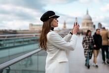 Elegant Female Tourist Taking Pictures With Her Mobile Phone