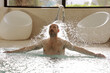 © Rene de Haan/Stocksy - man under water jet in swimming pool