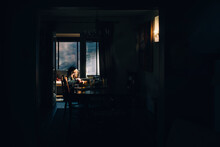 Girl At Table In Ray Of Light