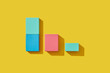 © Yaroslav Danylchenko/Stocksy - Square shaped wooden blocks lying on yellow background