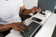 © Ezequiel Giménez/Stocksy - Crop black man shopping online
