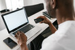 © Ezequiel Giménez/Stocksy - Black man making online transaction