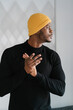 © Ezequiel Giménez/Stocksy - Black man rubbing hands and looking away