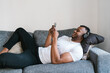 © Ezequiel Giménez/Stocksy - Black man watching video on smartphone