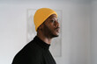 © Ezequiel Giménez/Stocksy - Pensive African American man looking away