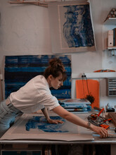 Woman Painting In Craft Studio Using Tools