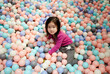 © ChaoShu Li/Stocksy - Adorable little Asian girl playing in the stack of bubble balls