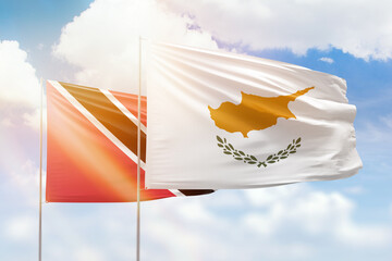 Sunny blue sky and flags of cyprus and trinidad and tobago