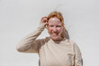 © Bisual Studio/Stocksy - Joyful lady with ginger hair smiling in sunlight