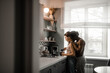 © Dima Sikorski/Stocksy - A guy hugs his girlfriend who makes coffee in the morning