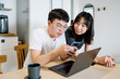 © ZQZ Studio/Stocksy - Young couple using computer together at home