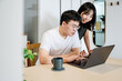 © ZQZ Studio/Stocksy - Young couple using computer together at home