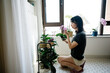 © ZQZ Studio/Stocksy - Young woman doing gardening at home