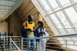 © VICTOR TORRES/Stocksy - Couple in university walking in staircase