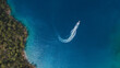 © Yakov Knyazev/Stocksy - drone view of a turning speedboat in azure water