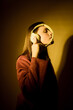 © Producciones Visualix/Stocksy - Girl listening to music in studio background