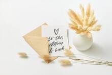 Envelope With Greeting Card Near Vase With Dry Wheat Ears