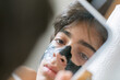 © ByLorena/Stocksy - Teen boy looking into small mirror
