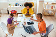 © BONNINSTUDIO/Stocksy - Diverse women working on creative project at table