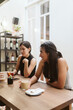 © Mal de Ojo Studio/Stocksy - Woman eating with friends and laughing