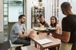 © Mal de Ojo Studio/Stocksy - Waiter serving a tray of desserts
