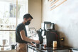 © Mal de Ojo Studio/Stocksy - Barista making a coffee at a coffee shop
