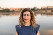 © Lupe Rodríguez/Stocksy - portrait of caucasian woman next to a river